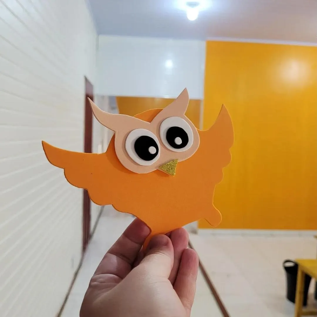 Coruja de EVA laranja no corredor da escola